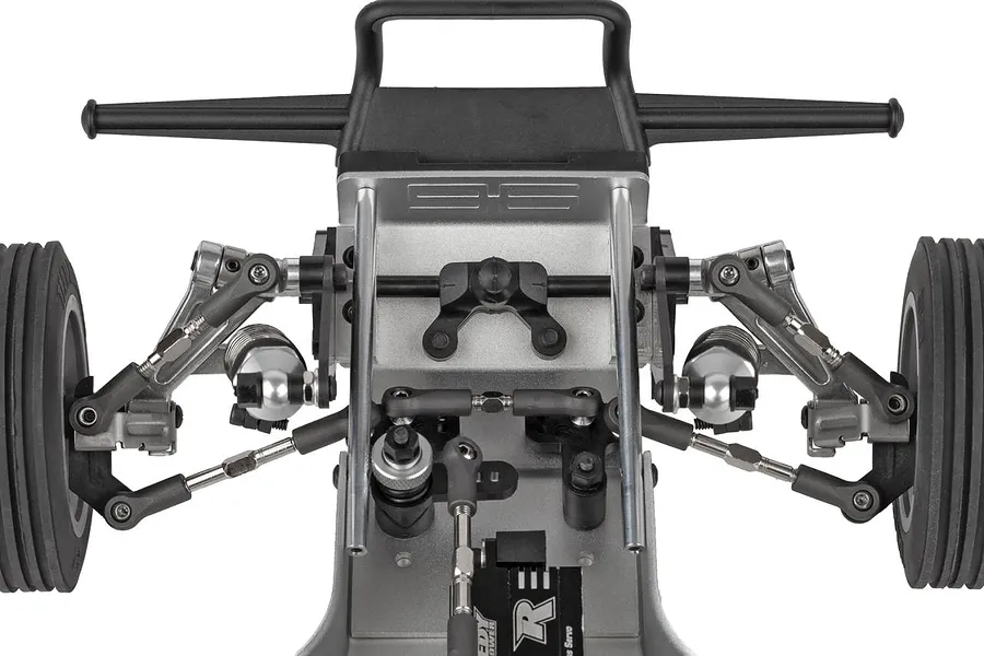 Close-up top-down view of the front suspension, steering components, bumper, and ribbed tires on the Team Associated RC10 Ultra Rider buggy.