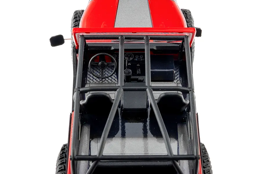 Top-down view of the interior and roll cage of the Axial SCX30 Jeep RC rock crawler in red.