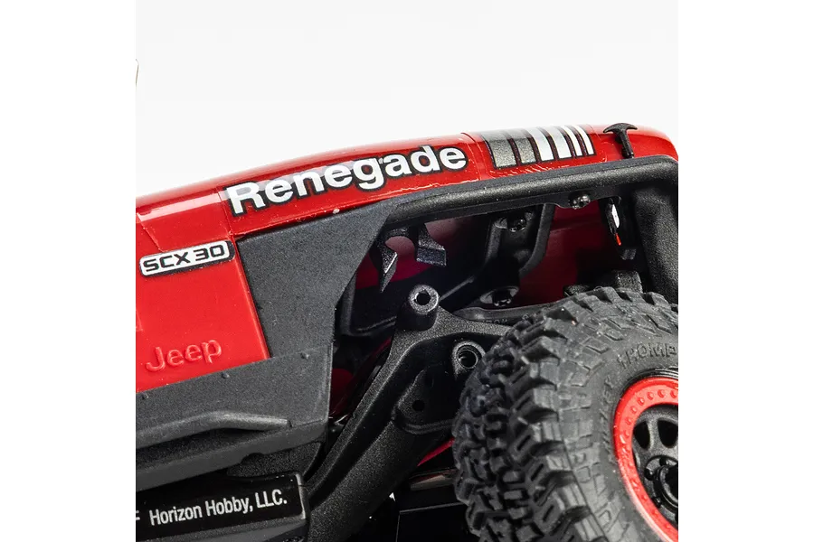 Close-up of the red Axial SCX30 Jeep CJ-7 Renegade RC crawler hood and front wheel area, showing Renegade and SCX30 branding.