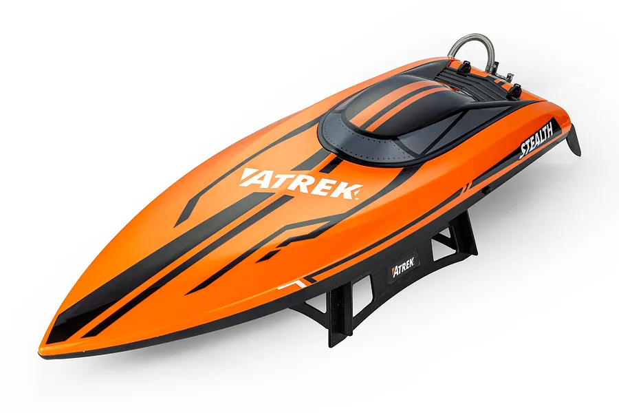 Atrek Stealth orange deep V RC speed boat resting on a black plastic display stand against a clean white background.