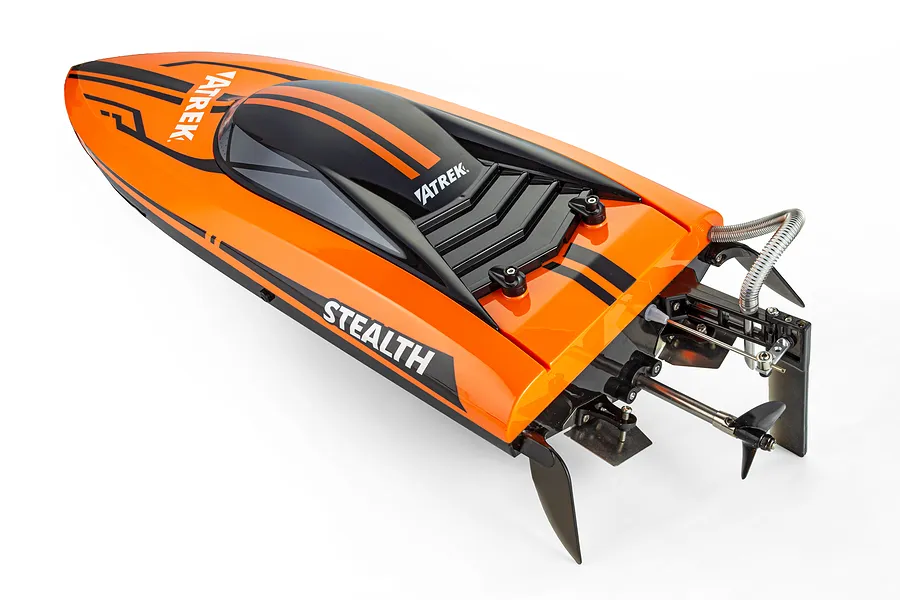 Atrek Stealth 25" Brushless RC Speed Boat in orange and black, viewed from a high angle showing its rear hardware, propeller, and rudder.