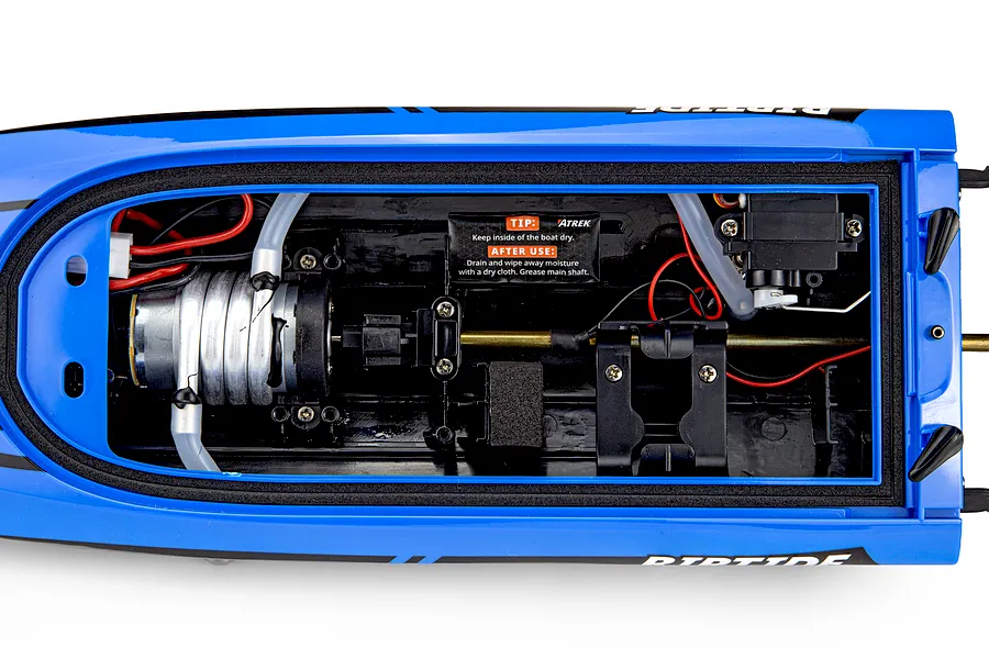Top-down view of the inside hull of the Atrek Riptide RC speed boat, showing the motor, cooling lines, steering servo, and wiring.