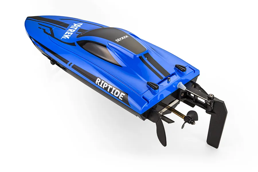 High angle studio shot of the Atrek Riptide 16 inch blue and black RC speed boat, showing hull, canopy, and stern hardware.