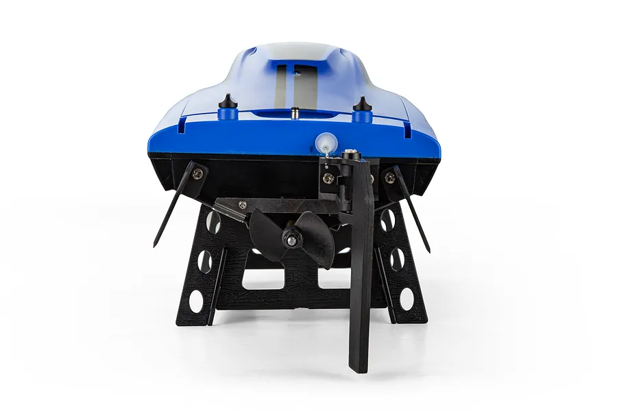 Rear view of the Atrek Riptide blue RC speed boat resting on a black plastic stand, showing the propeller, rudder, and trim tabs.