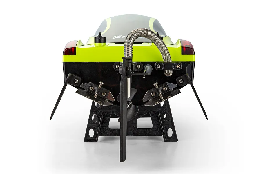 Rear view of the Atrek Rogue green RC speed boat resting on a black stand, showing the rudder, propeller, and trim tabs.