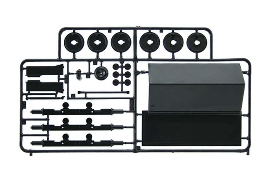 Black plastic model kit parts sprue containing wheel rims, axles, and structural components against a white background.