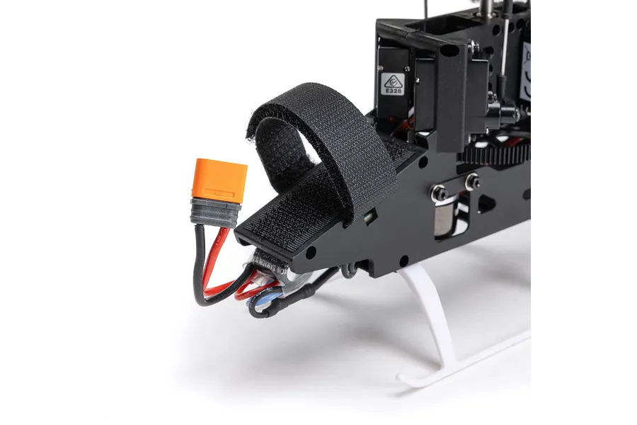 Close-up of the front battery compartment and orange IC2 connector on the Blade Revolution 155 CP RC helicopter.
