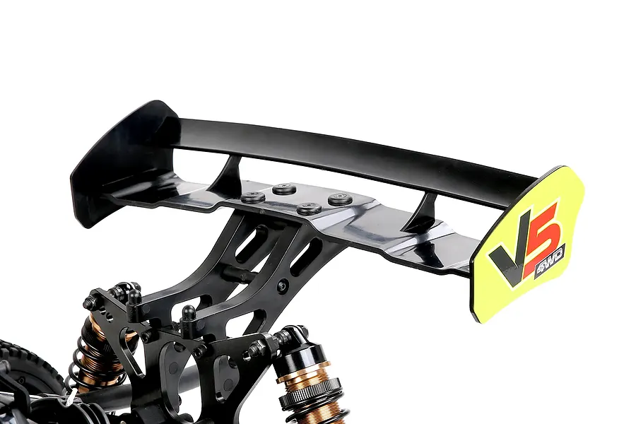 Close-up of a black RC rear wing mounted on a Rovan Voyager 5 with yellow V5 decals on a white background.