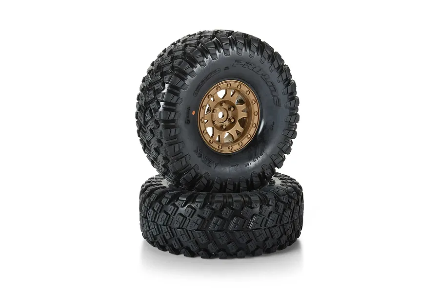 Pro-Line 1.9 inch Aztek G8 crawler tyres on bronze Impulse rims, shown as a pair of glued wheels against a white background.
