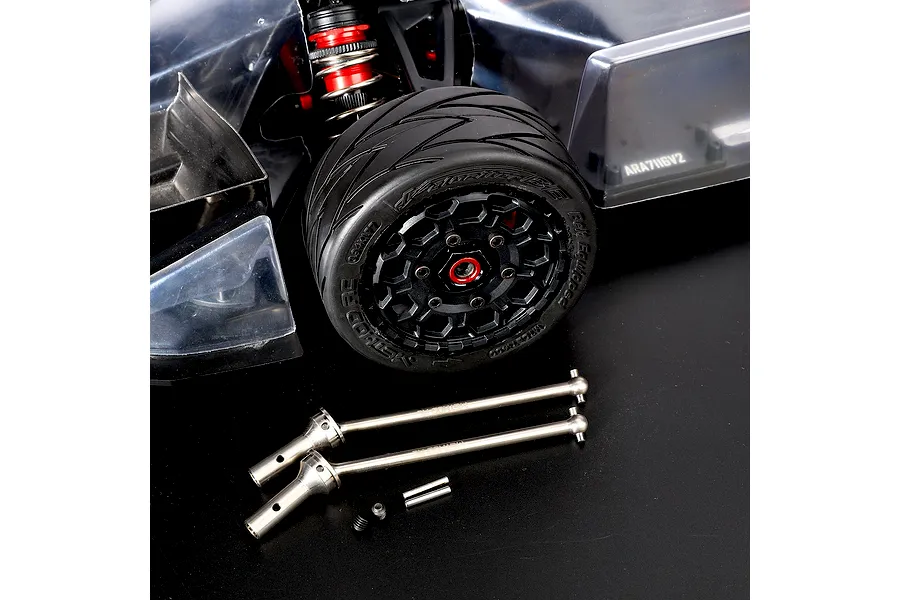 Method RC titanium CVD driveshafts displayed in front of an RC car wheel, shock, and chassis.