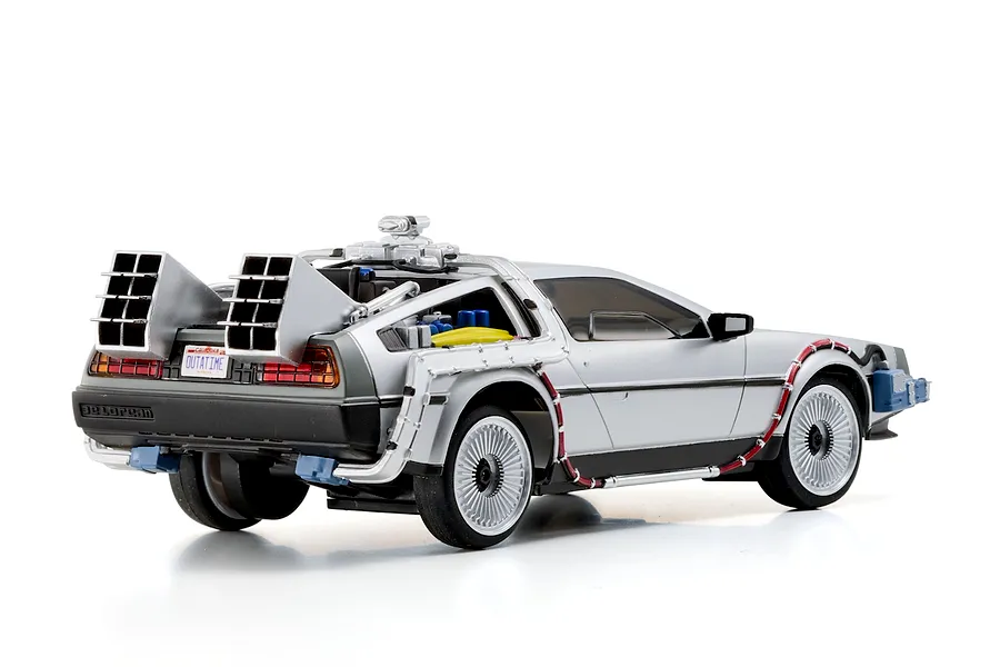 Rear-three-quarter studio shot of the Kyosho First Mini-Z Back to the Future DeLorean RC car, showing detailed time machine modifications.