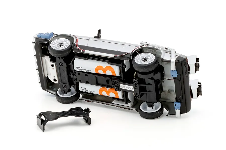 Underside view of the Kyosho First Mini-Z Back to the Future DeLorean RC car showing battery compartment and detached battery door.