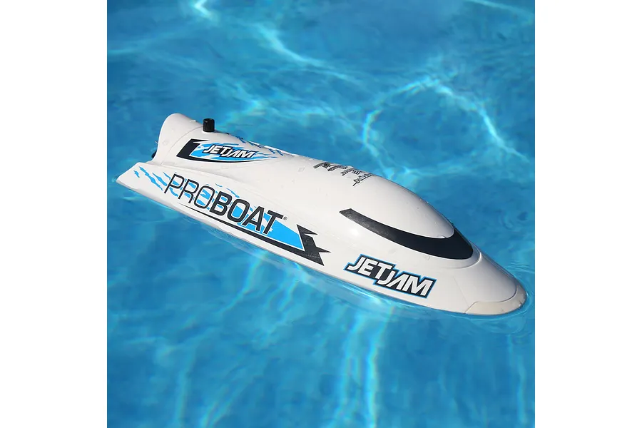 Pro Boat Jet Jam V2 electric RC speed boat in white floating on clear blue pool water.