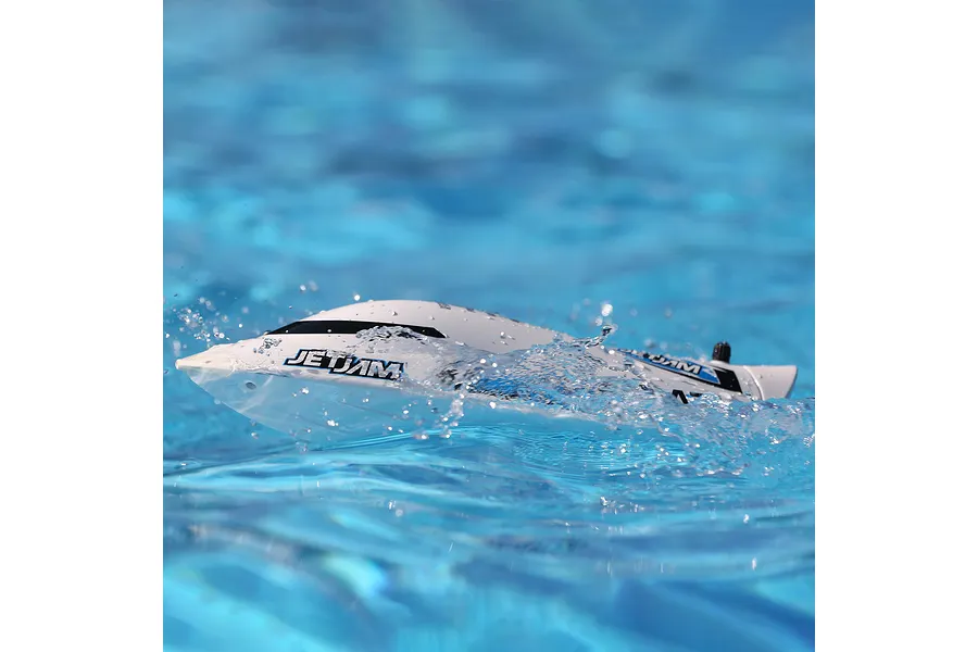 Pro Boat Jet Jam V2 electric RC speed boat running across blue water, kicking up splashes with the Jet Jam logo visible.