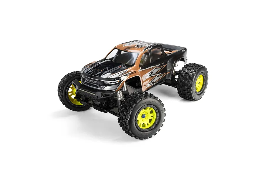 A 1/5 scale RC monster truck featuring Badlands MX43 tyres on yellow and black Impulse rims, shown mounted on a Ram body against a white background.
