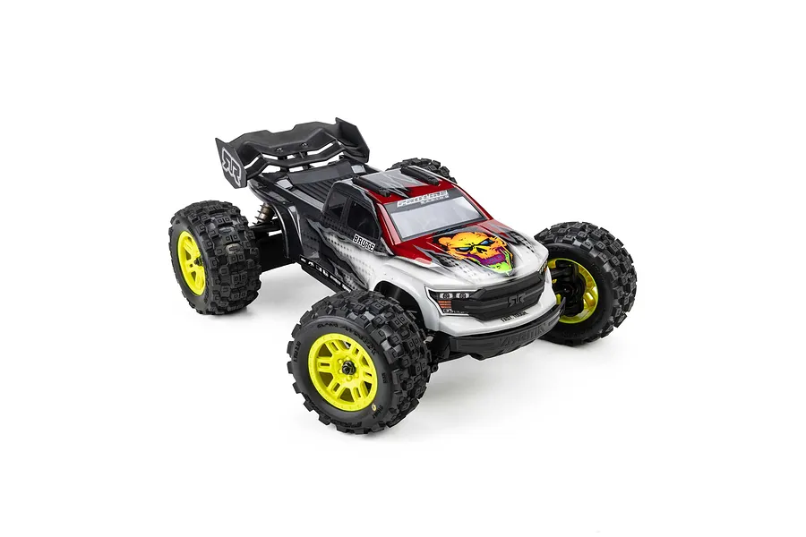 Monster RC truck installed with Pro-Line Badlands MX MT tyres on yellow split six rims against a white background.