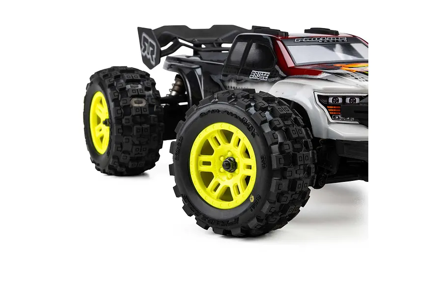 Pro-Line 1/16 Badlands MX MT tyres mounted on yellow split six rims installed on an RC truck against a white background.