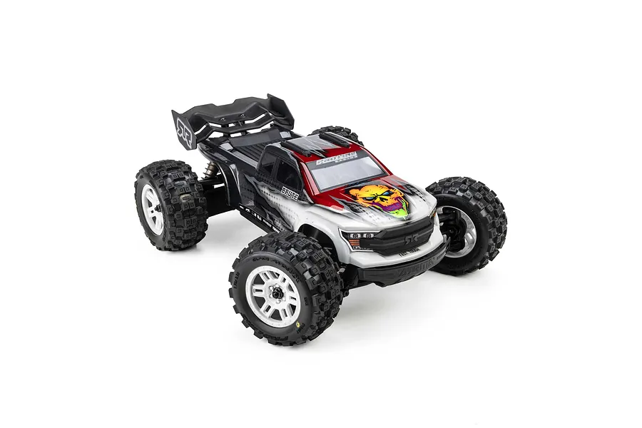 Pro-Line 1/16 Badlands MX MT tyres mounted on white split-six rims installed on an RC monster truck.