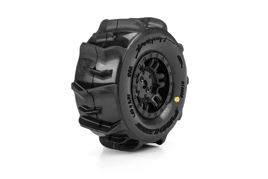 Single Pro-Line 1/16 Dumont paddle tyre mounted on a black split-six rim against a white background.