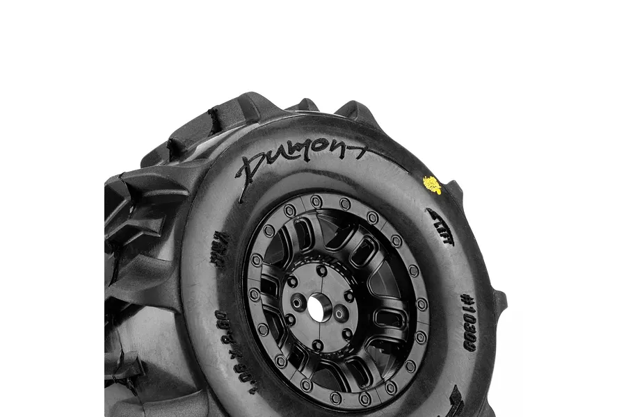 Close-up studio shot of a Pro-Line Dumont paddle tyre mounted on a black split-six rim against a white background.