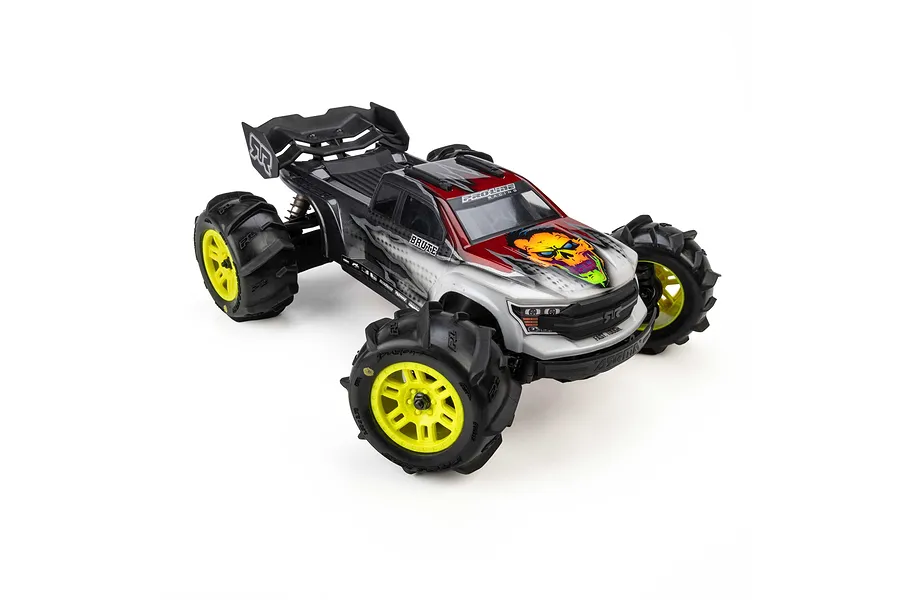 Pro-Line 1/16 Dumont paddle tyres mounted on yellow split-six wheels installed on an RC monster truck against a white background.