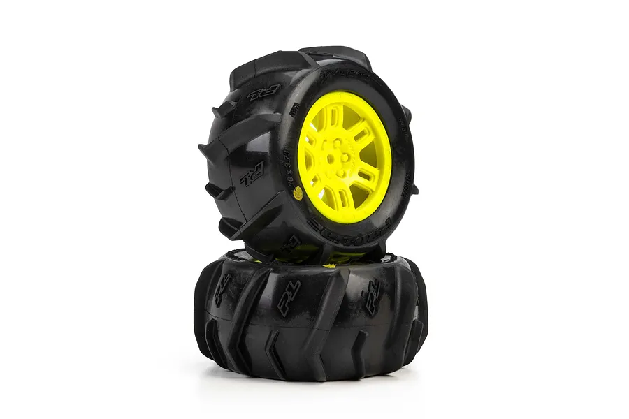 Pro-Line Dumont paddle tyres mounted on yellow split-six wheels, stacked against a white background.