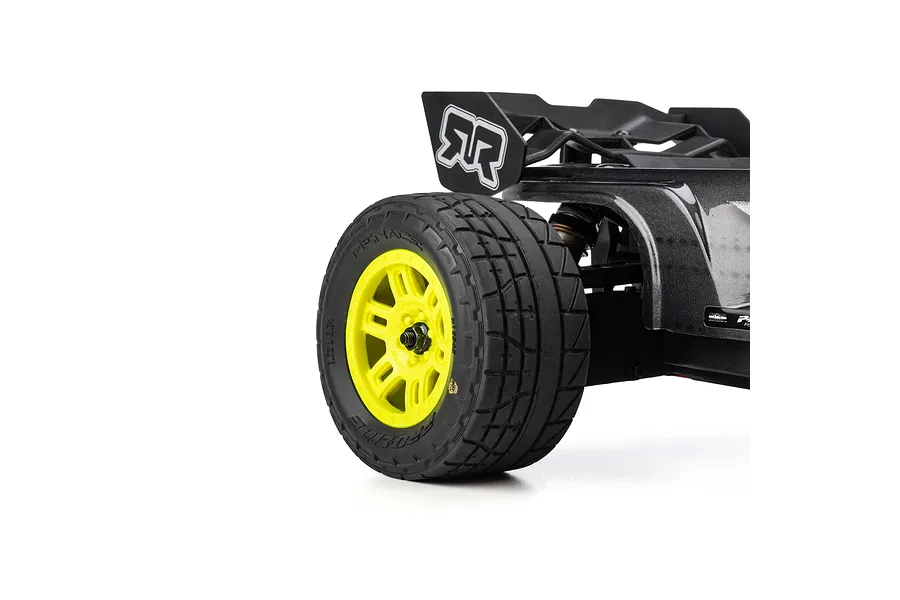 Pro-Line 1/16 Menace street tyre mounted on yellow split-six rim fitted to the rear of an RC car.