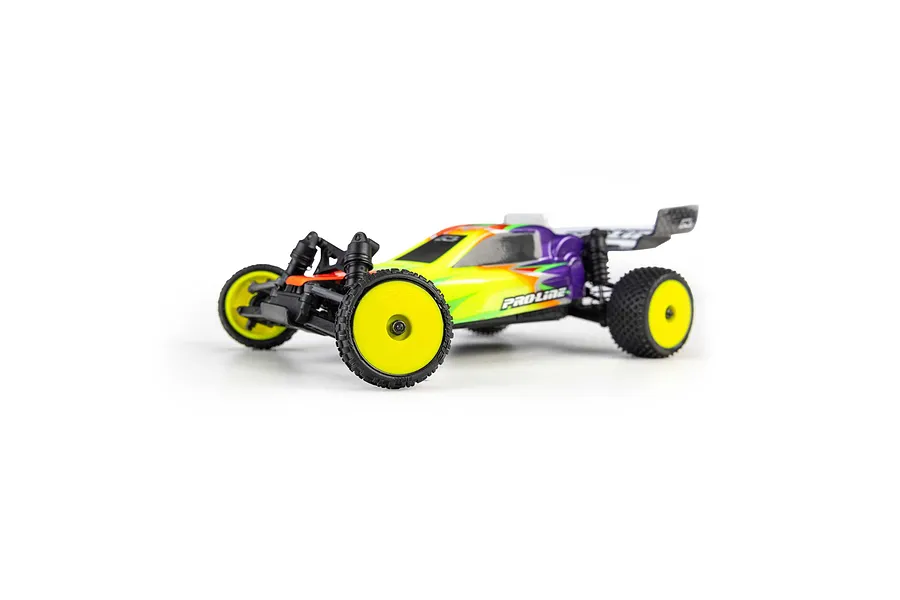 Pro-Line 1/24 scale RC buggy installed with yellow dish rims and black rubber carpet tyres on a white background.
