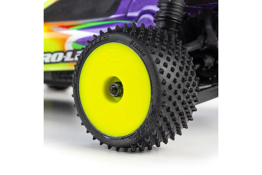 Close-up of a Pro-Line studded carpet tyre mounted on a yellow dish rim installed on an RC car.
