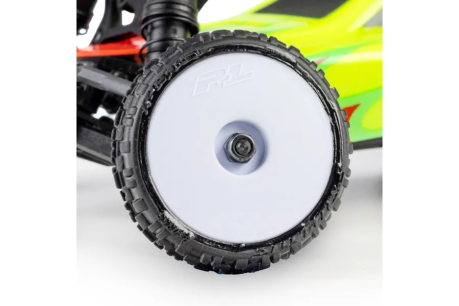 Close-up of a Pro-Line RC buggy wheel mounted with a patterned tyre and white rim on a vehicle chassis.