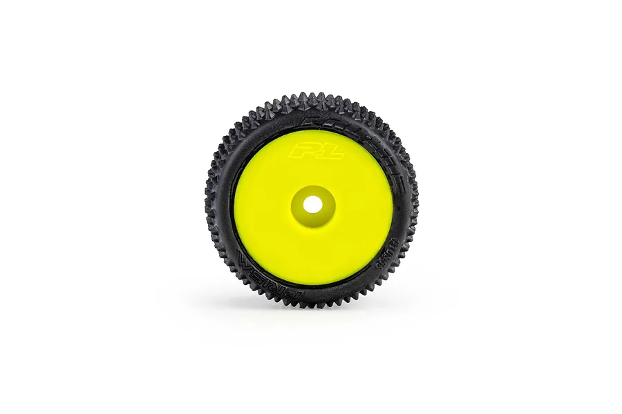 Pro-Line 1/28 Prism carpet tyre mounted on a bright yellow dish rim against a clean white background.