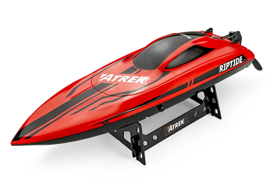 Atrek Riptide red RC speed boat resting on a black plastic display stand against a clean white background.