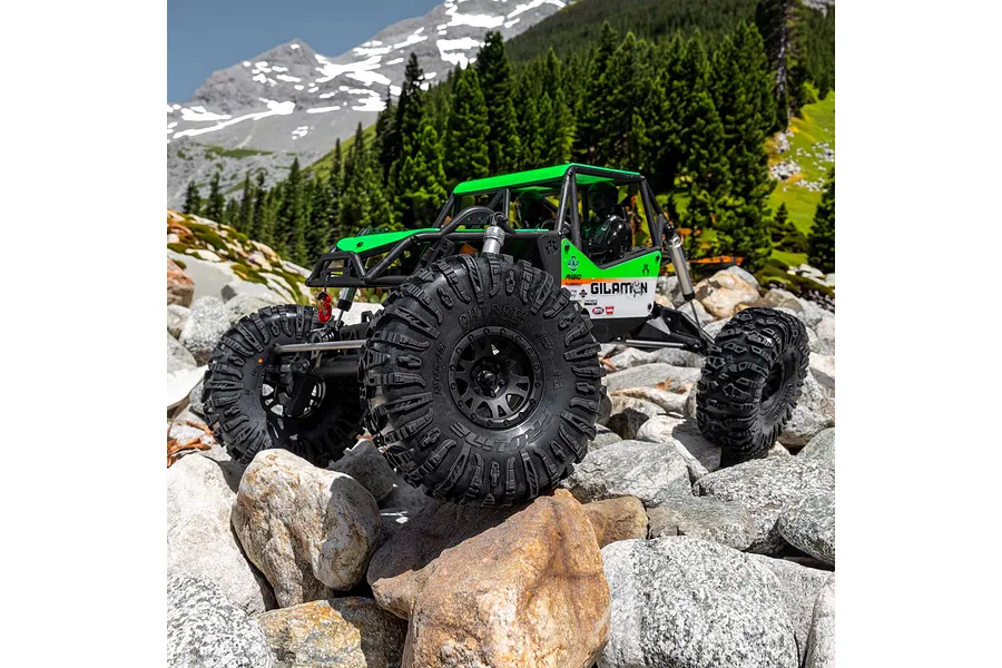 Pro-Line 2.2 inch Chisel II crawler tyres fitted to an RC rock crawler traversing an outdoor rocky mountain landscape.