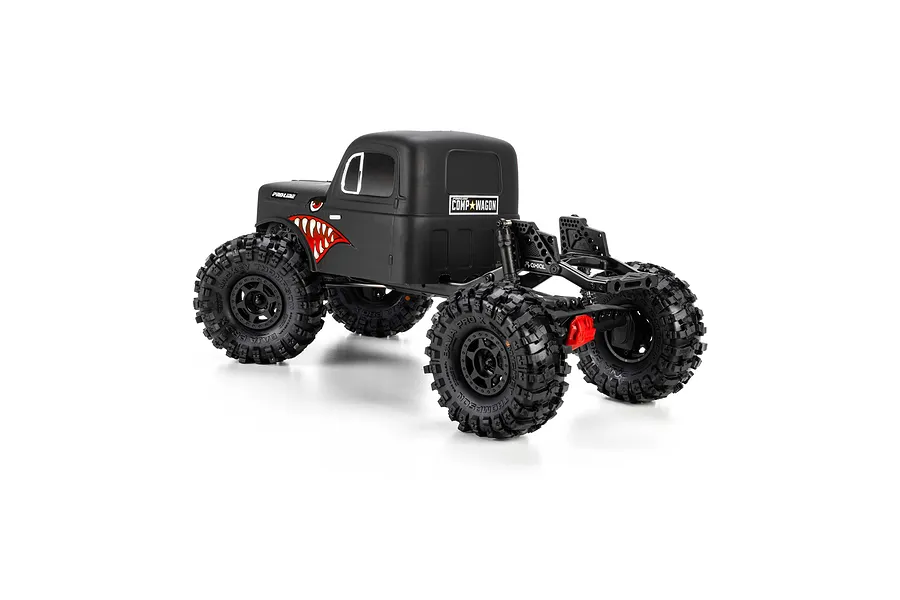 Pro-Line matte black cab-only crawler body mounted on an RC chassis with large off-road tires against a white background.