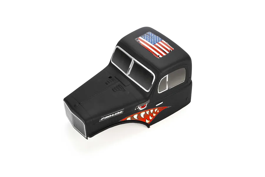 Pro-Line matte black cab-only crawler body shell with American flag roof decal and shark teeth side graphics on a white background.