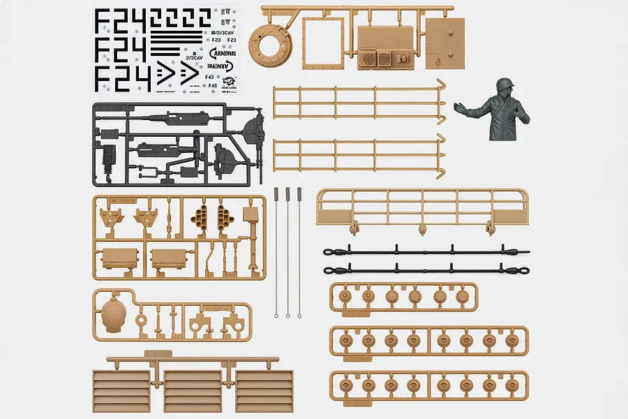 Top-down view of Heng Long 1/16 M1A2 Abrams tank accessory pack including plastic sprues, decals, wire cables, and a figure.