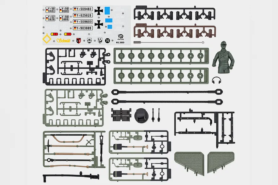 Heng Long 1/16 German Leopard 2 A6 tank accessory pack including decal sheet, plastic parts trees, commander figure, and tow cables on white background.