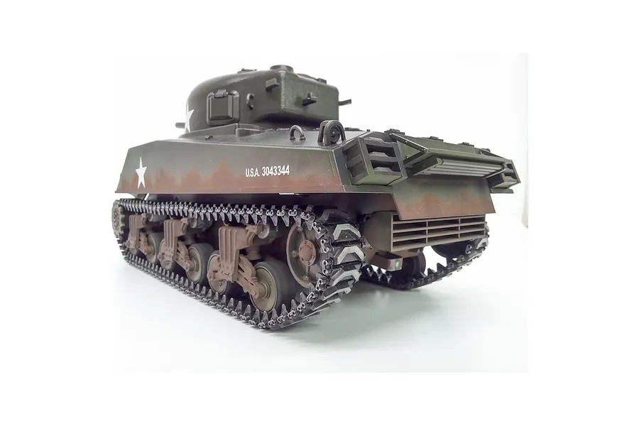 Rear three-quarter view of the Taigen M4A3 Sherman RC tank showing tracks, suspension, and weathered olive drab hull.