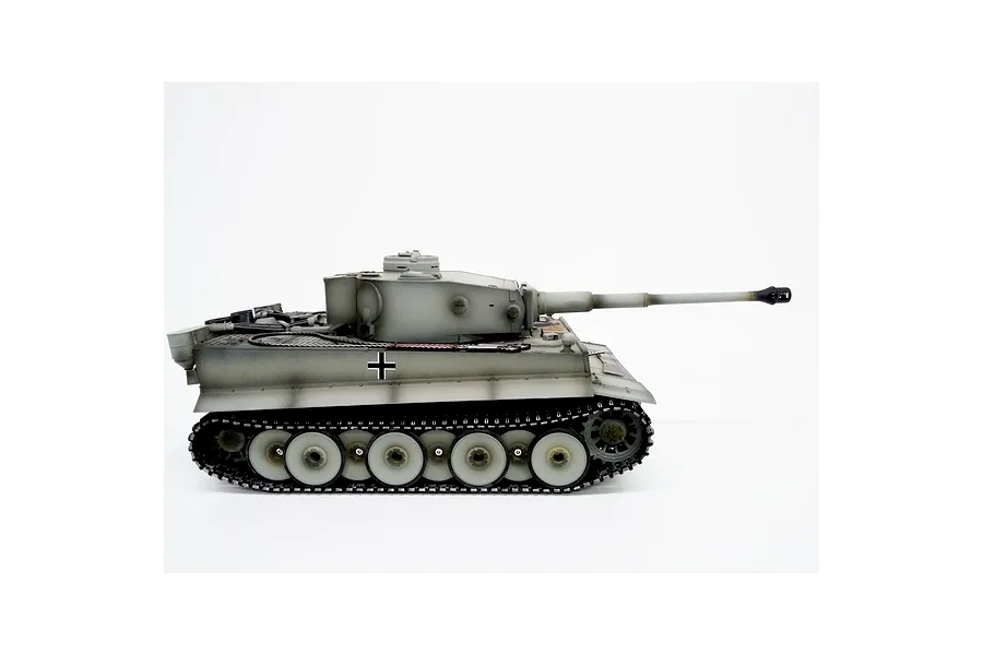 Side view of Taigen German Tiger I RC tank in grey camouflage with black tracks against a white background.