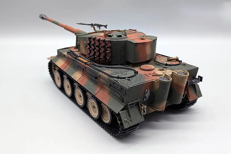 Taigen German Tiger I RC tank in camouflage finish viewed from the rear-quarter angle against a plain white studio background.