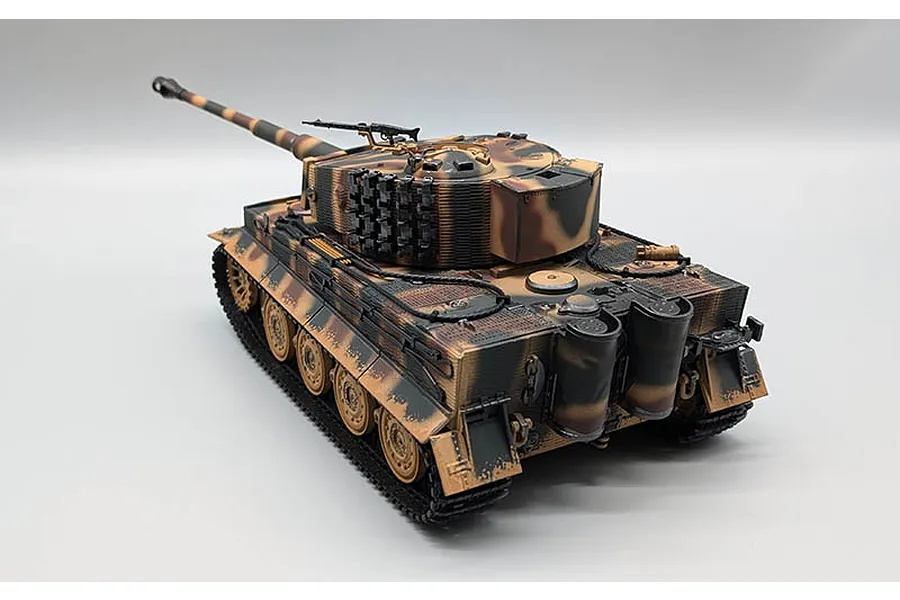 High-angle studio shot of the Taigen German Tiger I RC tank in a camouflage pattern, showing tracks, turret, and barrel against a plain white background.