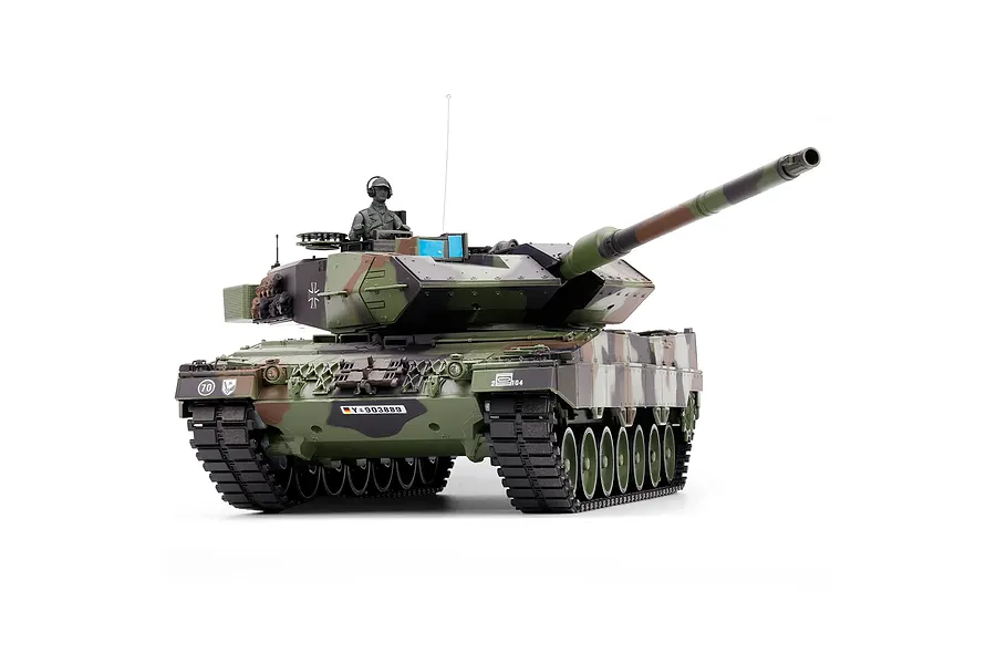 Taigen 1/16 scale German Leopard 2A6 RC tank in multi-colour camouflage with commander figure against a white background.