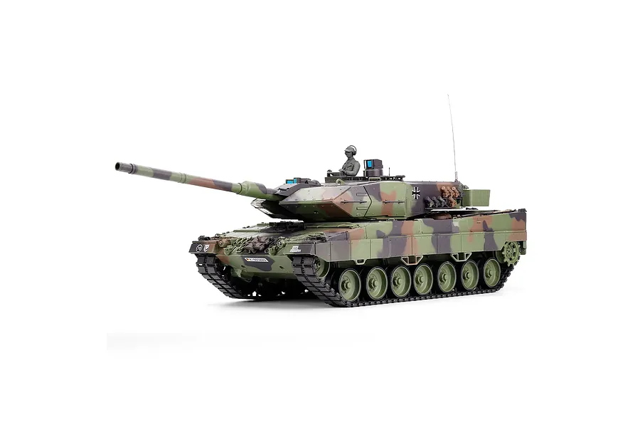 Taigen German Leopard 2A6 RC tank studio shot on white background, showing camouflage paint and commander figure.