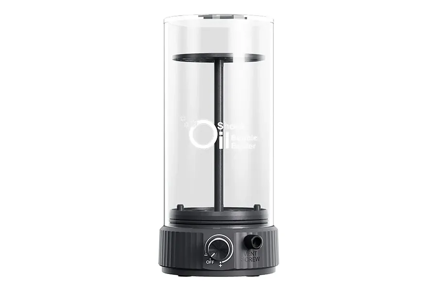 SkyRC Shock Oil Bubble Buster device featuring a clear cylindrical chamber and a dark grey base with a control knob and vent screw.