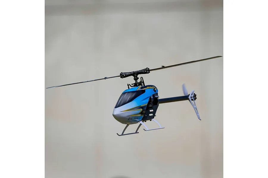 Blade Revolution 155 CP RC helicopter in flight against a neutral indoor background