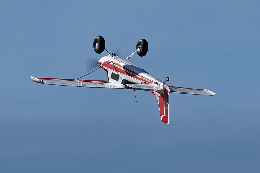 Inverted flight of the Arrows RC Bigfoot 1.3m trainer airplane against a clear blue sky.