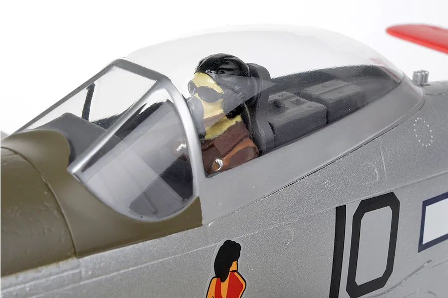 Close-up of the cockpit and pilot figure on the Arrows RC P-51 Mustang 850mm plane against a white background.