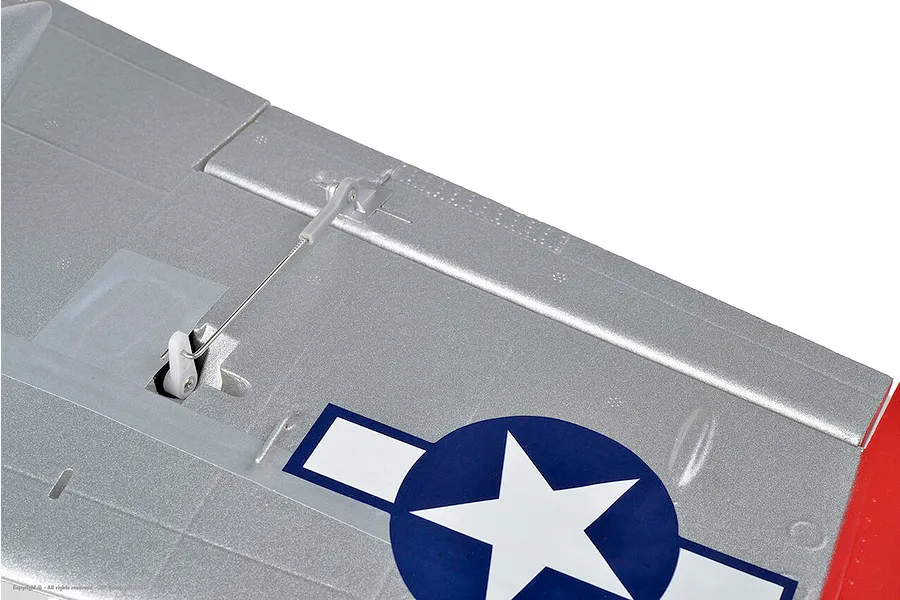 Close-up view of the silver foam wing and control linkage on the Arrows RC P-51 Mustang model plane.