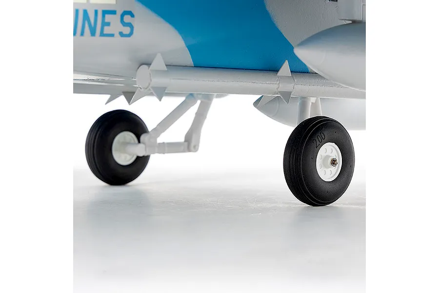 Close-up of landing gear, wheels, and underside of the FMS F/A-18 Hornet RC jet model against a white background.