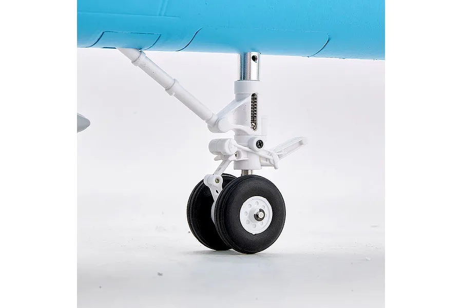 Close-up studio shot of the retractable landing gear with dual wheels on the FMS F/A-18 Hornet RC plane against a plain white background.